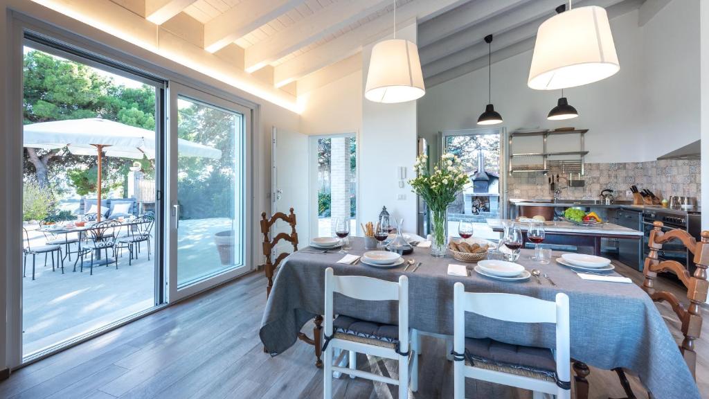 une cuisine et une salle à manger avec une table et des chaises dans l'établissement Dimora Campo delle Mura - Charming House, à Acquaviva Picena
