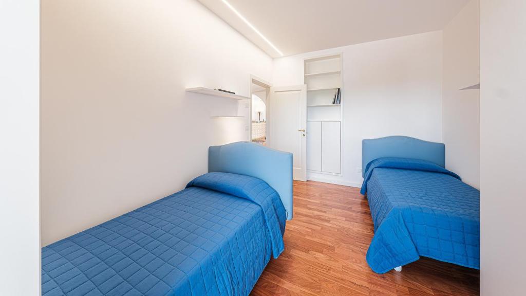 - 2 lits bleus dans une chambre dotée de parquet dans l'établissement VILLA BELLINA 6, Emma Villas, à Ostuni