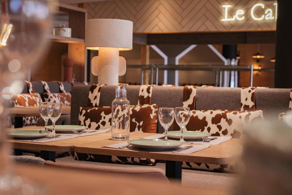 une table avec des assiettes et des verres à vin dessus dans l'établissement Belambra Clubs Avoriaz - Les Cimes du Soleil, à Avoriaz