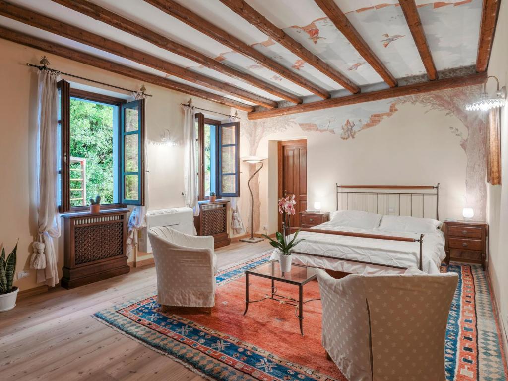 une chambre avec un lit, une table et des chaises dans l'établissement TENUTA NAVELLI 12&2, Emma Villas, à Salò