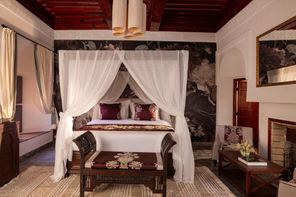 une chambre avec un lit à baldaquin dans l'établissement Riad Laz Mouassine & Wellness, à Marrakech