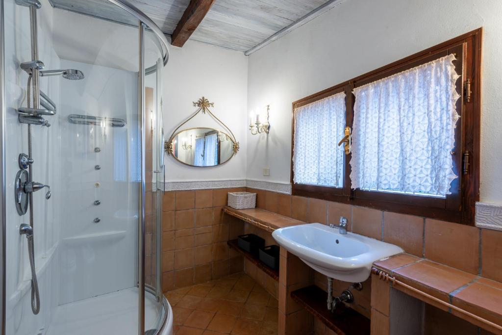 une salle de bain avec un lavabo et une douche dans l'établissement Porto Ercole Prestige Villa, à Cala Galera