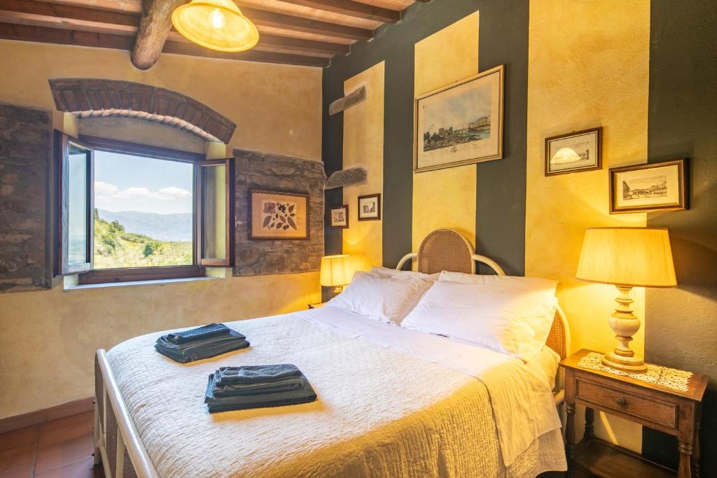 une chambre avec un lit avec deux sacs dessus dans l'établissement Casale Giaggiolo, à Incisa in Valdarno