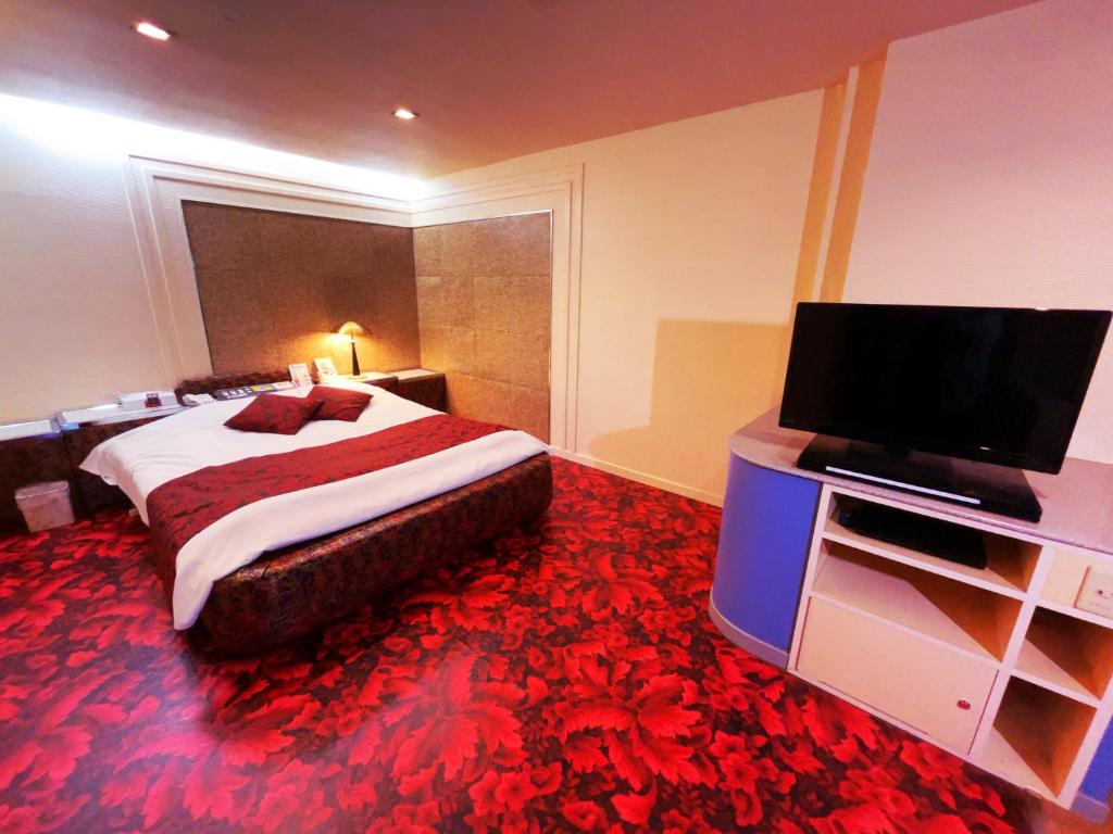 une chambre avec un lit et une télévision à écran plat dans l'établissement HOTEL K's GOMANGOKU adult only, à Takatsuka 15 autres photos