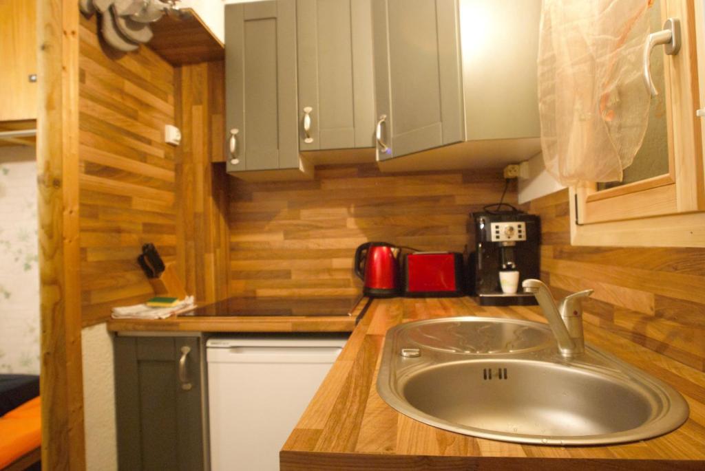 une cuisine avec un évier dans une petite maison dans l'établissement Ski1600 - GrandMassif, à Samoëns