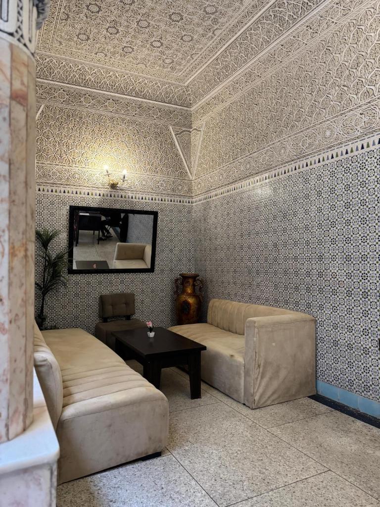 un salon avec un canapé et une table dans l'établissement Riad Blue Garden, à Rabat