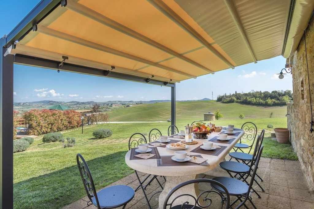une table et des chaises sur une terrasse avec vue dans l'établissement Villa I Cipressini piscina riscaldata spa Toscana, à Pienza 42 autres photos