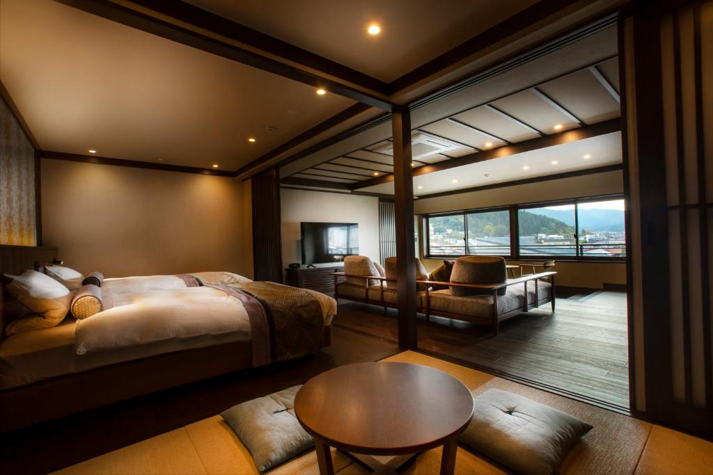 une chambre avec un grand lit et une table dans l'établissement まち宿 壱龍 MACHIYADO ICHIRYU, à Takayama