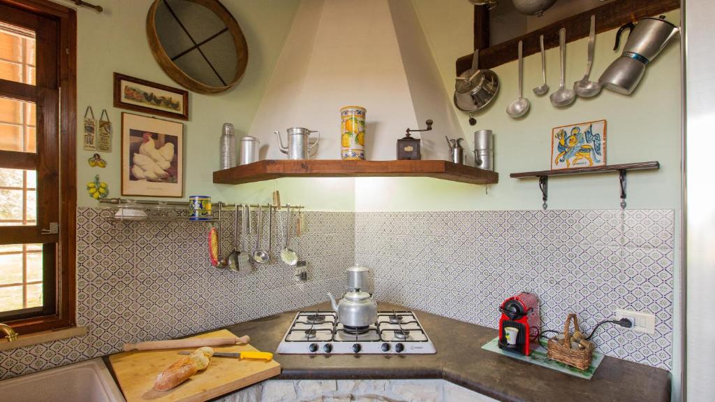 une cuisine avec une cuisinière et un comptoir dans l'établissement Il Giardino Dei Limoni 8, Emma Villas, à Ispica