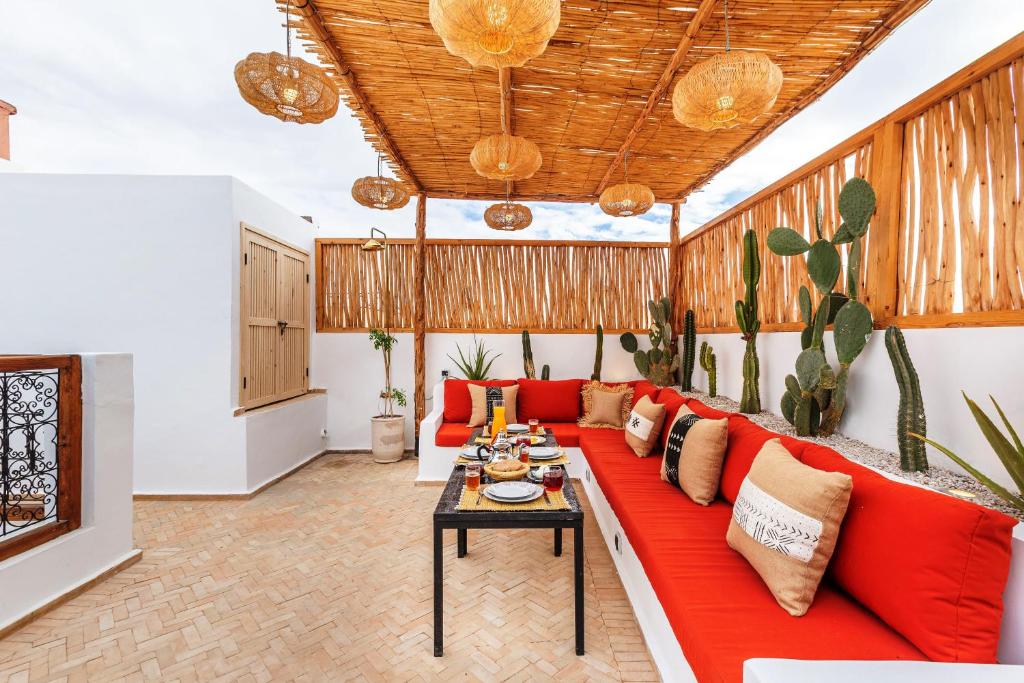 un salon avec un canapé rouge et une table dans l'établissement Riad Dar Yamina Exclusif - Morrocan Breakfast, à Marrakech