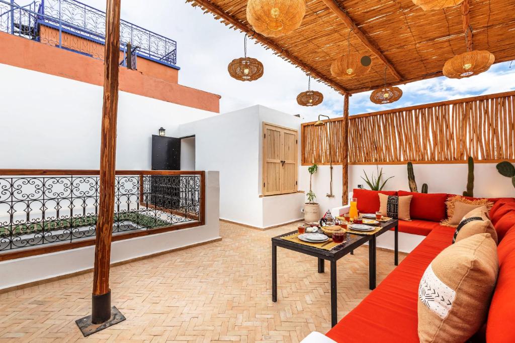 un salon avec un canapé rouge et une table dans l'établissement Riad Dar Yamina Exclusif - Morrocan Breakfast, à Marrakech