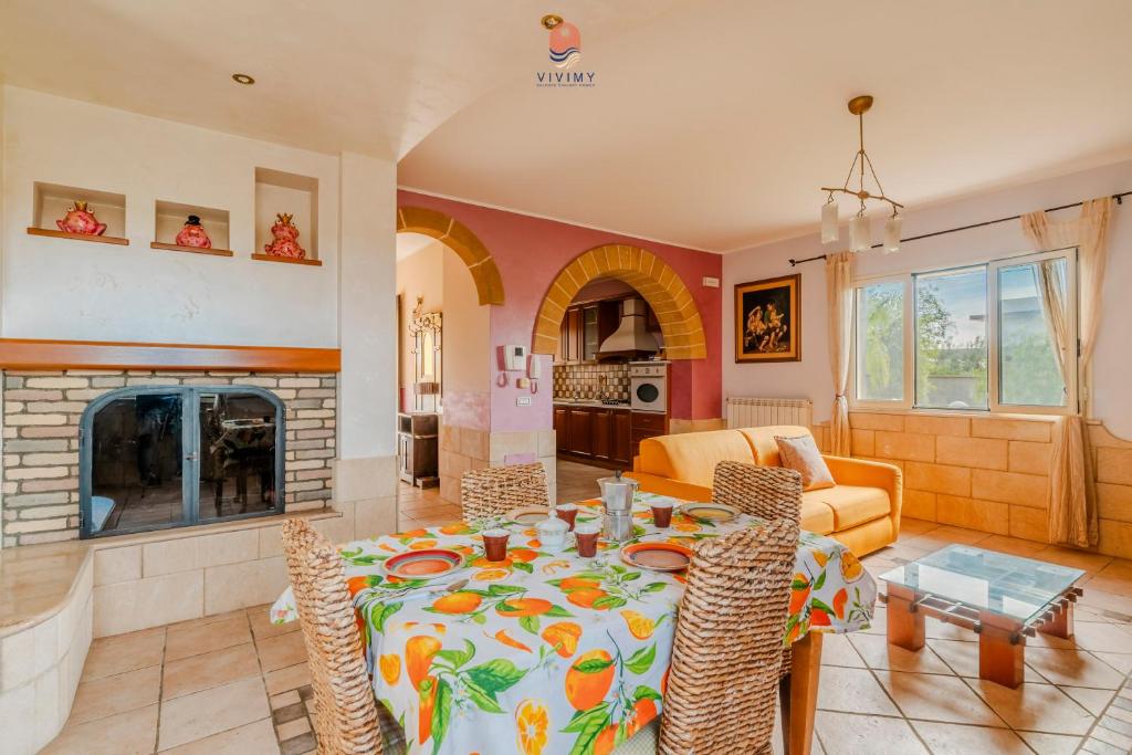 un salon avec une table et une cheminée dans l'établissement Villa Diletta by Vivimy, à Casarano