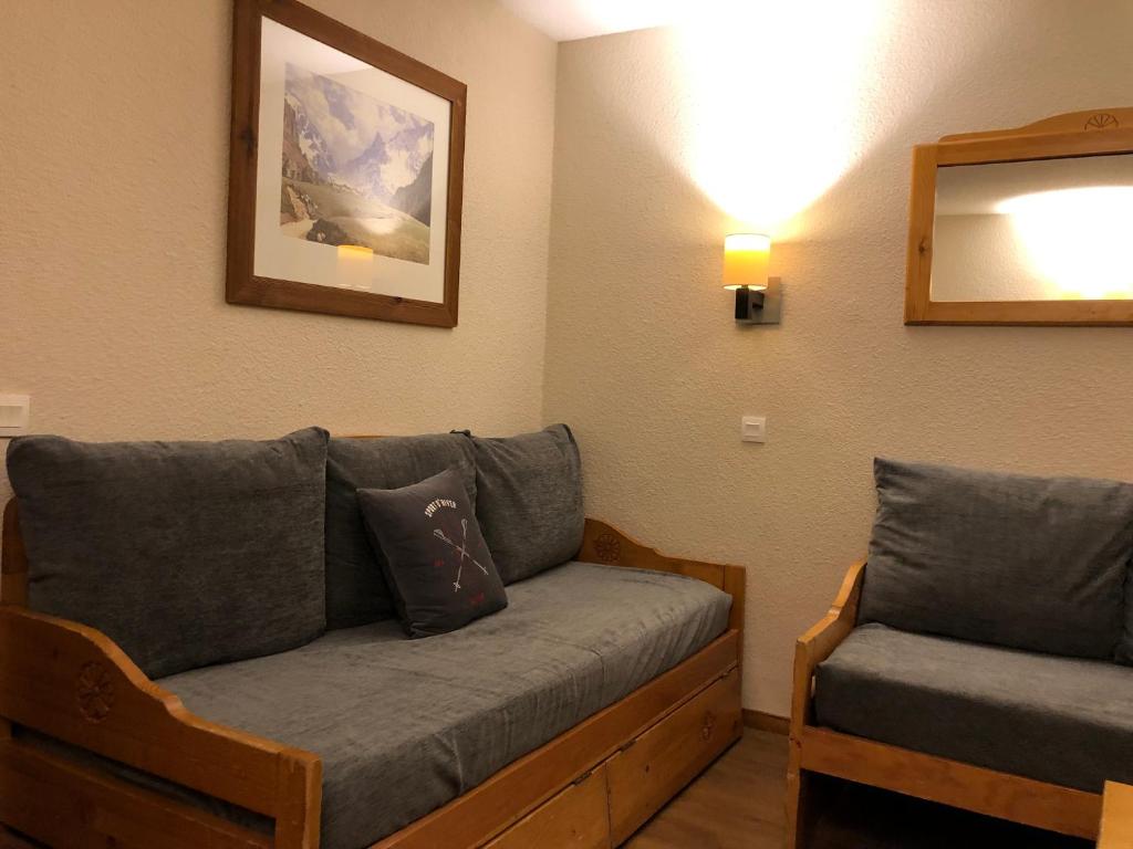 un salon avec un canapé et un miroir dans l'établissement L'Eterlou on pistes,Val Thorens, à Val Thorens