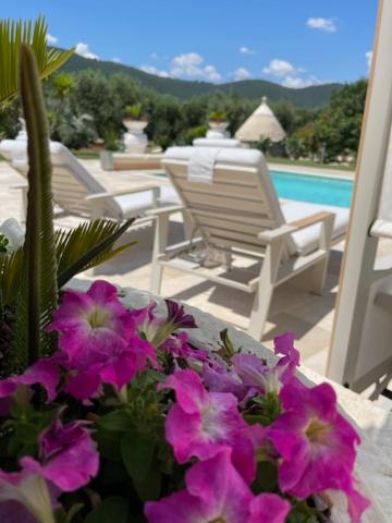 un vase rempli de fleurs violettes posé sur une terrasse dans l'établissement Villa Forester - Puglia Mia Apartments, à Monopoli
