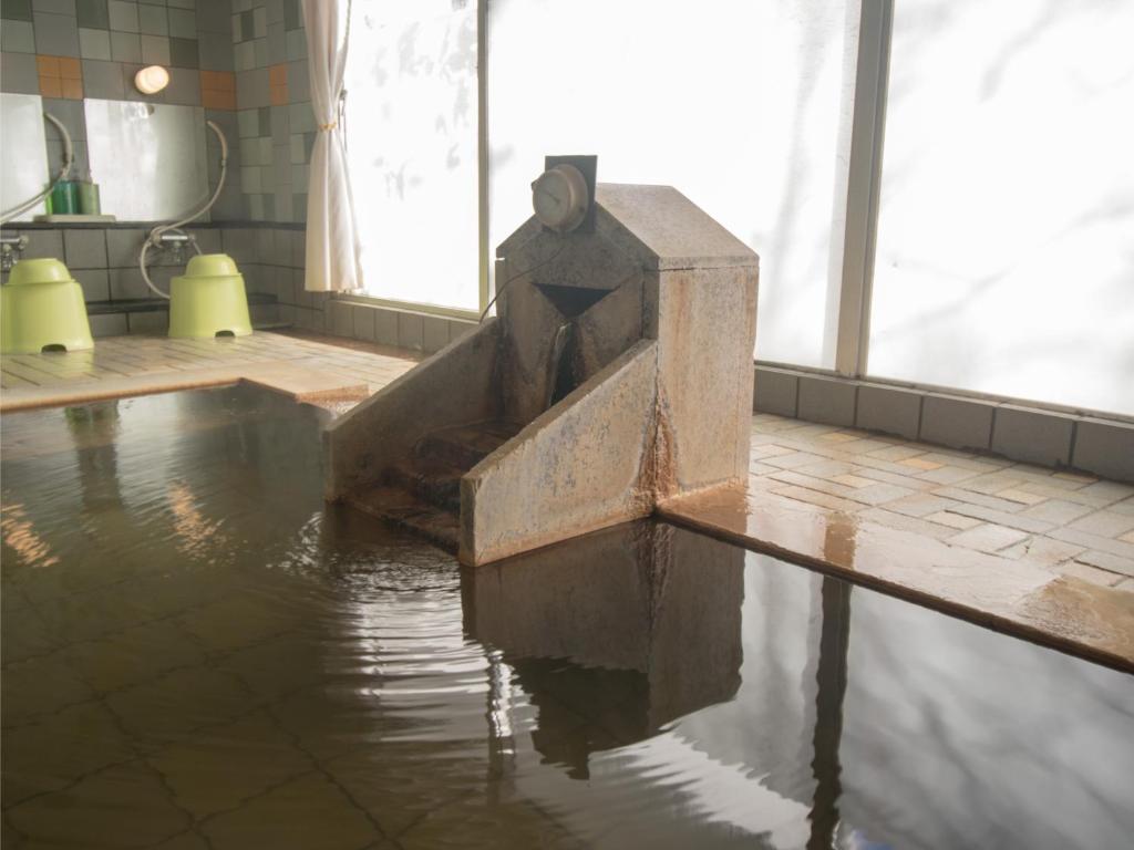 La salle de bains est pourvue d'une baignoire remplie d'eau. dans l'établissement Villa Inawashiro, à Inawashiro 27 autres photos