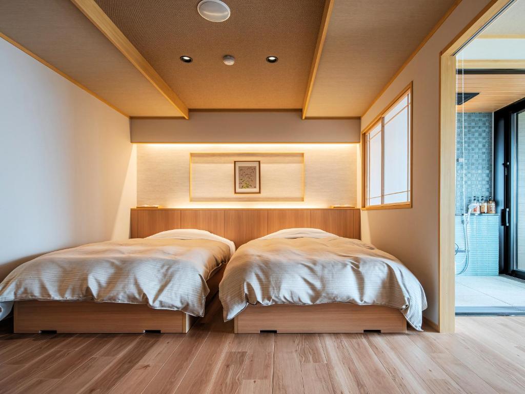 deux lits dans une chambre avec parquet dans l'établissement Omori, à Shibukawa 88 autres photos