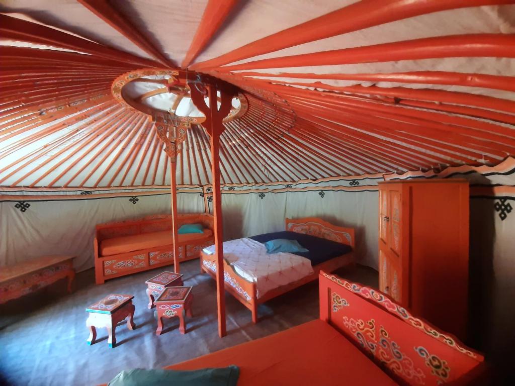 une chambre avec un lit dans une tente dans l'établissement Yourtes Corse Le pré aux biches, à Zonza