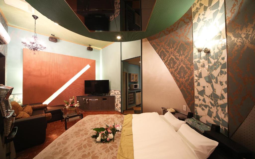 Cette chambre comprend un lit fleuri. dans l'établissement ハーフムーン富士宮 Adult only, à Fujinomiya