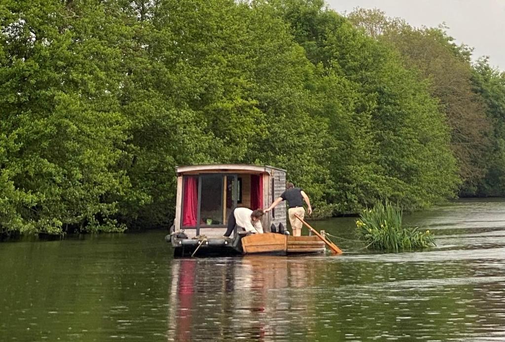 2 personnes sur un petit bateau dans une rivière dans l'établissement Patouillet bateau naviguant, à Saint-Vincent-sur-Oust