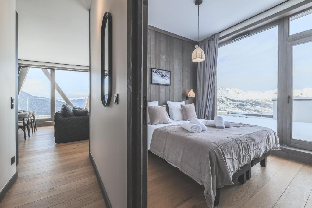 - une chambre avec un lit et une vue sur les montagnes dans l'établissement TERRESENS - Le Quartz - NEW, à Peisey-Nancroix