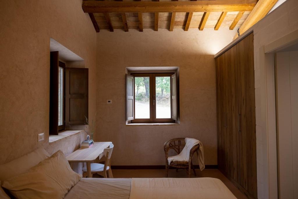 une chambre avec un lit, une table et une fenêtre dans l'établissement Casa Santo Stefano, à San Girolamo di Sopra