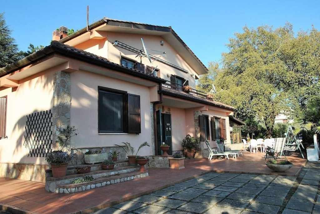 une maison avec une terrasse en face de celle-ci dans l'établissement Villa Vallereale giardino e piscina uso esclusivo, à Itri