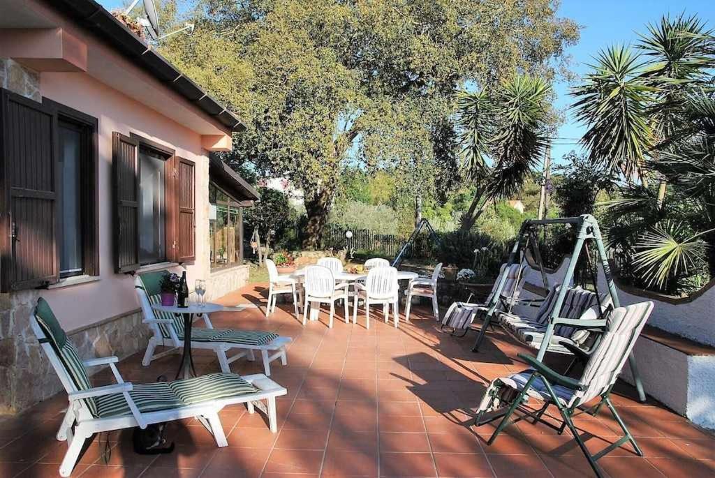 d'une terrasse avec des chaises, une table et une machine. dans l'établissement Villa Vallereale giardino e piscina uso esclusivo, à Itri 25 autres photos