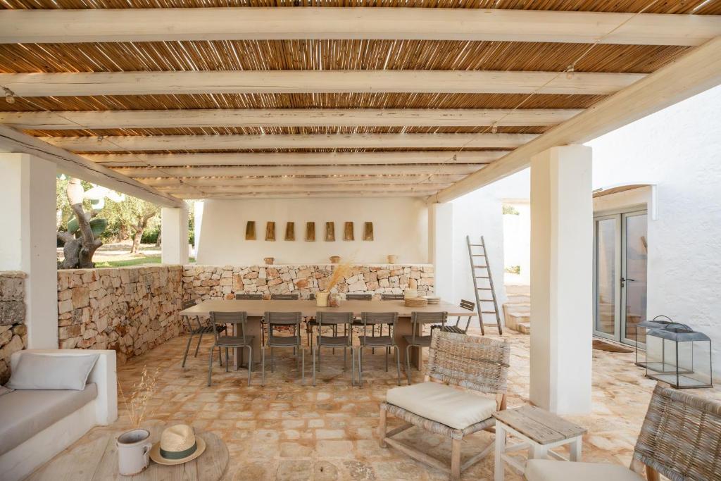 un salon avec une table et des chaises dans l'établissement Masseria Borgopietra, à Ostuni