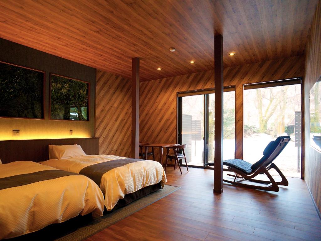 une chambre avec un lit et une chaise dedans dans l'établissement 一水荘, à Gosen 70 autres photos