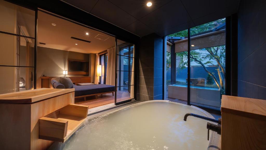 - une grande salle de bains avec baignoire et une chambre dans l'établissement Nasu-Onsen Shinshun no Kago Hewitt Resort, à Nasu
