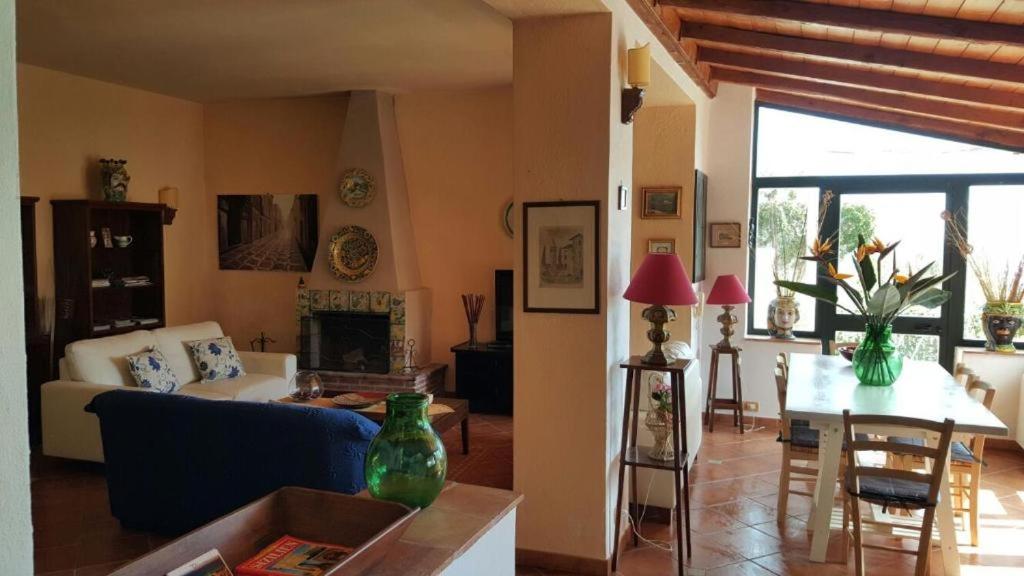 un salon avec un canapé et une table dans l'établissement Casa il Faro villa con piscina, à Castelmola