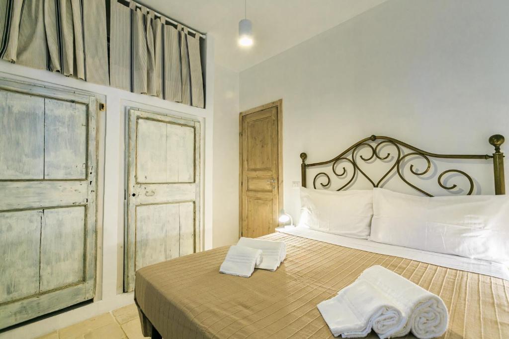 une chambre avec un lit avec deux serviettes dessus dans l'établissement Le Dimore di Trulli Mandorlo con piscina esclusiva, à Putignano 21 autres photos
