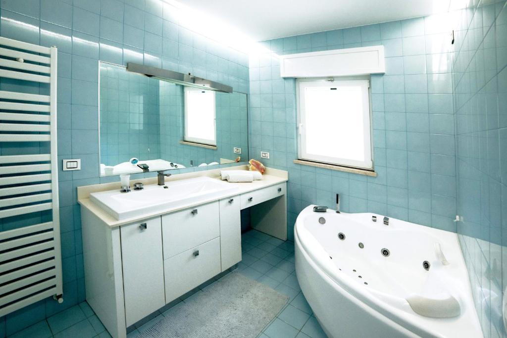 une salle de bain avec une baignoire et un lavabo et une baignoire dans l'établissement Villa Sapore Di Sale, à Alliste 27 autres photos