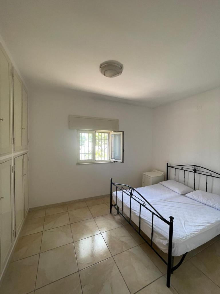 une chambre blanche avec un lit et une fenêtre dans l'établissement Maracaibo Village, à Tarente