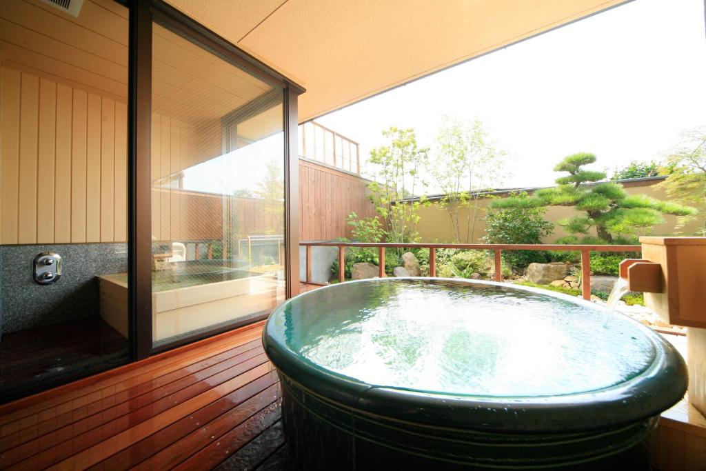une grande baignoire verte assise sur une terrasse dans l'établissement Mikasa, à Nara 22 autres photos