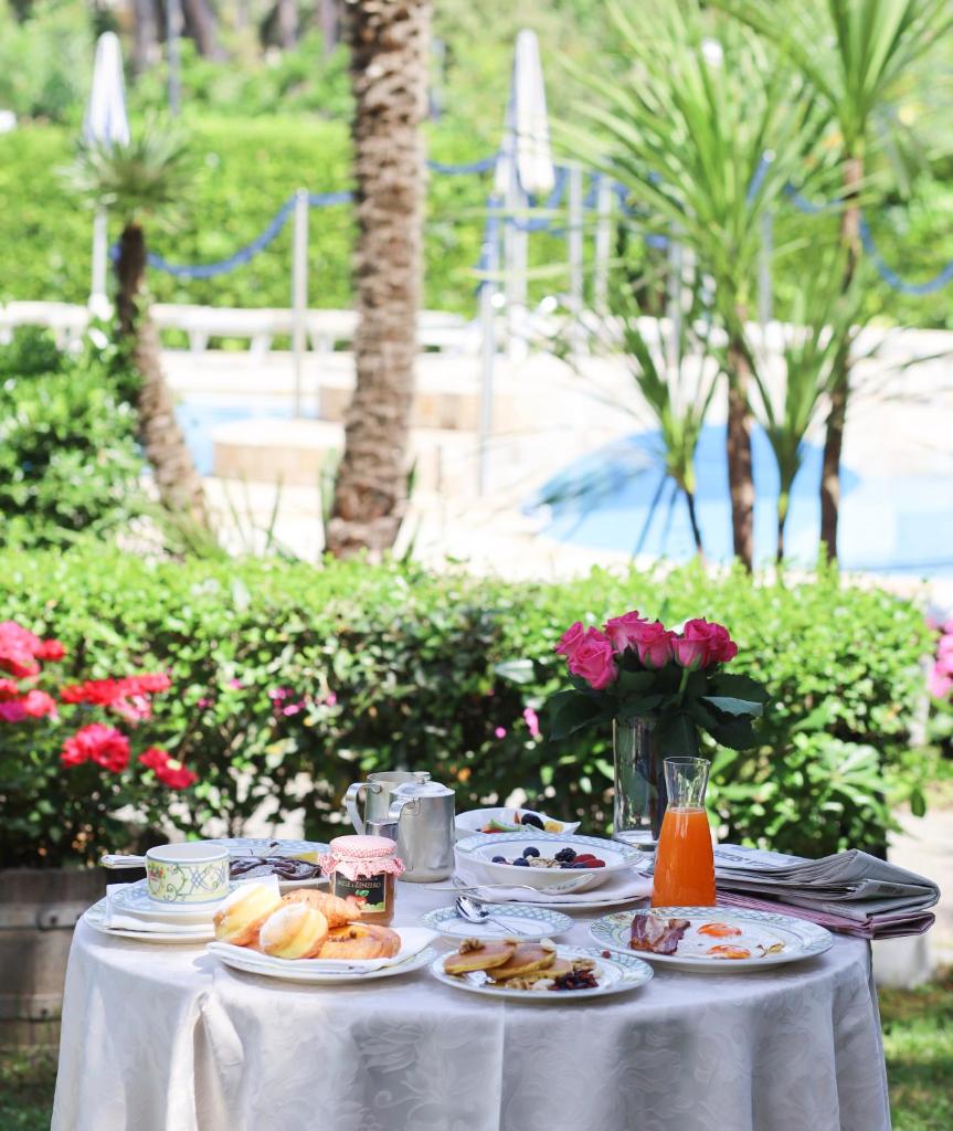 une table blanche avec des assiettes de nourriture dessus dans l'établissement Grand Hotel Gallia, à Milano Marittima