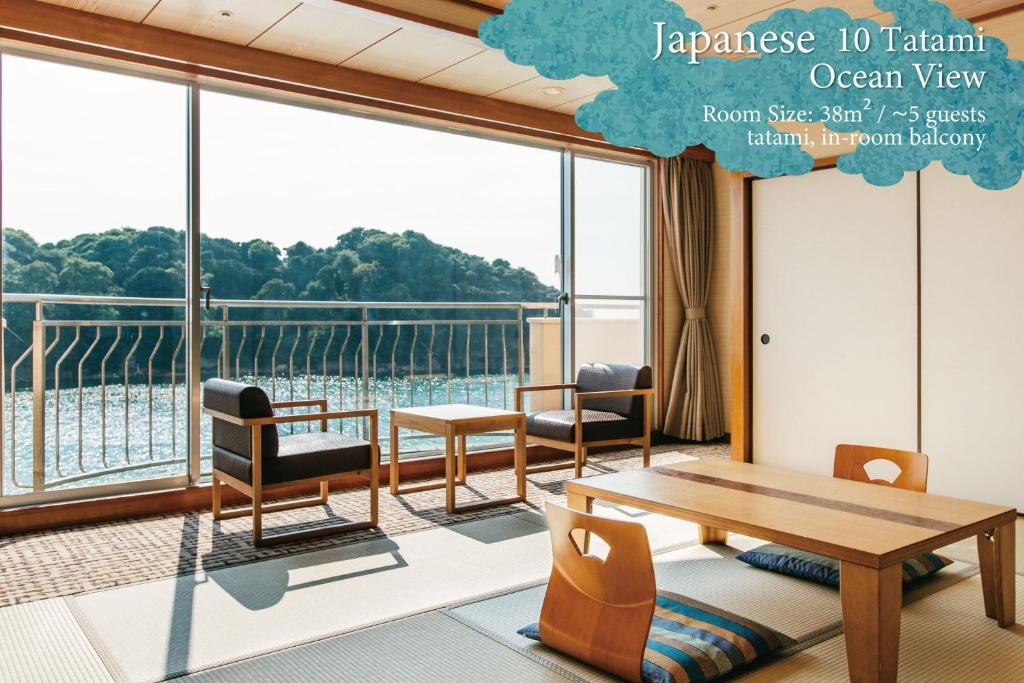 une pièce avec une table et des chaises et une grande fenêtre dans l'établissement KAMENOI HOTEL Kii-Tanabe, à Tanabe