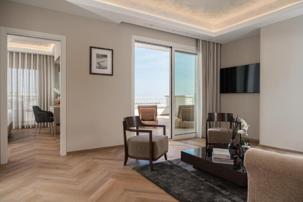 un salon avec un canapé et une table dans l'établissement Grand Hotel Gallia, à Milano Marittima