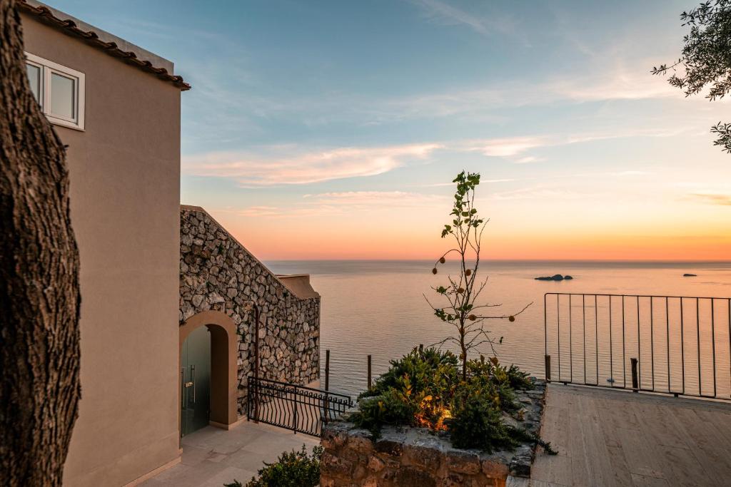 une maison avec vue sur l'océan au coucher du soleil dans l'établissement Antalia Boutique Hotel, à Positano