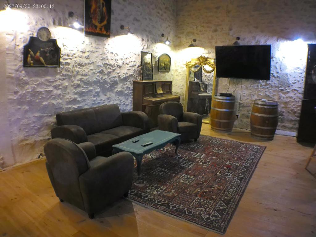 Il comprend un salon doté d'un canapé, de chaises et d'une télévision à écran plat. dans l'établissement gite de charme dans les vignes, à Massugas