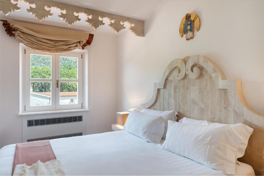 une chambre avec un lit blanc et une fenêtre dans l'établissement Santavenere Hotel, à Maratea
