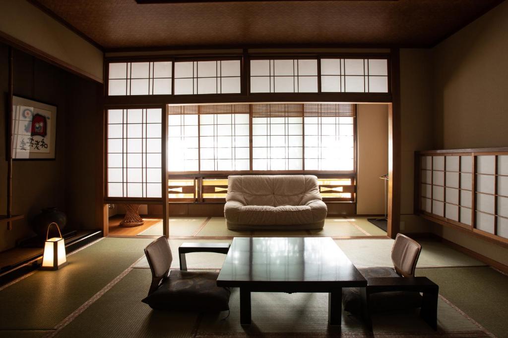 un salon avec un canapé et une table dans l'établissement 城崎温泉 旅館 つばき乃 - Kinosaki Onsen Ryokan Tsubakino, à Toyooka