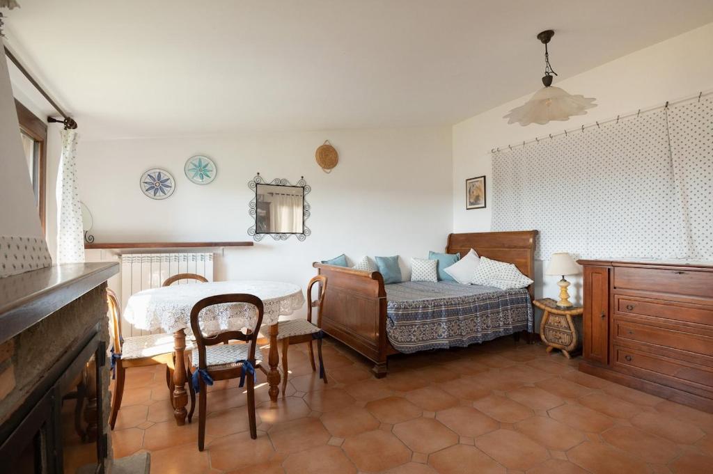 une chambre avec un lit, une table et des chaises dans l'établissement Villa immersed in green Isola dei Cavalli, à Quadroni