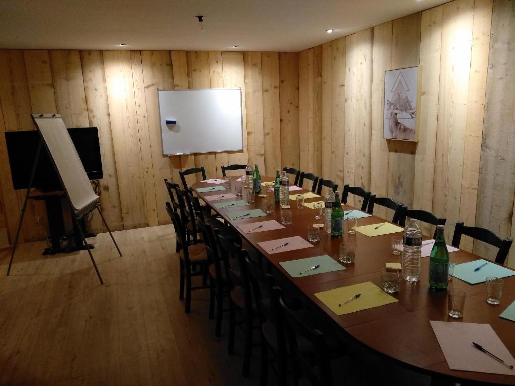 une salle de conférence avec une longue table et des chaises dans l'établissement Yourtes Olachat proche Annecy, à Faverges