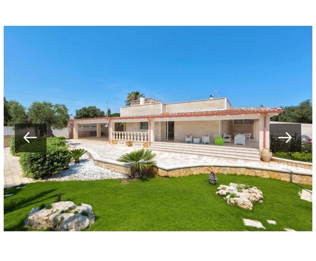 une grande maison avec une grande cour en face dans l'établissement Villa Ilaria, à Capitolo