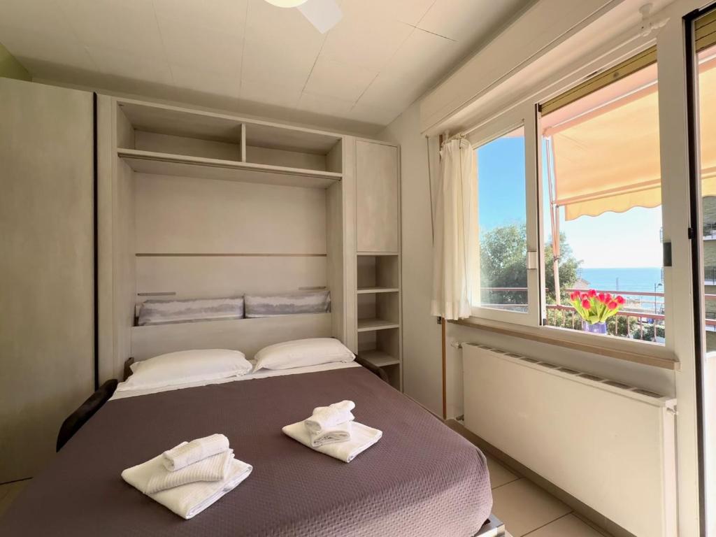 une chambre avec un lit avec deux serviettes dessus dans l'établissement Ligure Residence, à Pietra Ligure 54 autres photos