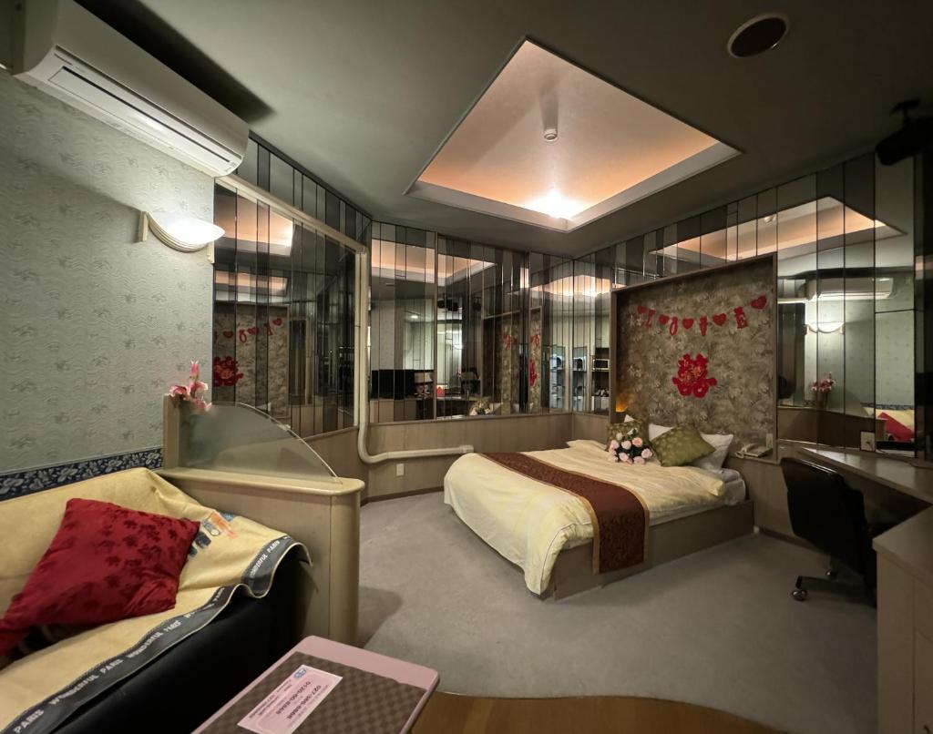 une chambre avec un lit, un bureau et un ordinateur dans l'établissement ホテル オリエント, à Takasaki