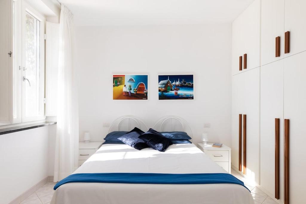 - une chambre blanche avec un lit et des oreillers bleus dans l'établissement Villa Elizabeth, à Conca dei Marini 28 autres photos