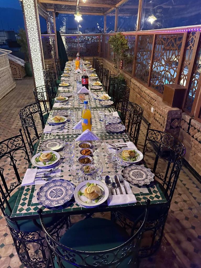 une longue table avec des assiettes de nourriture dans l'établissement Riad Asswar, à Rabat
