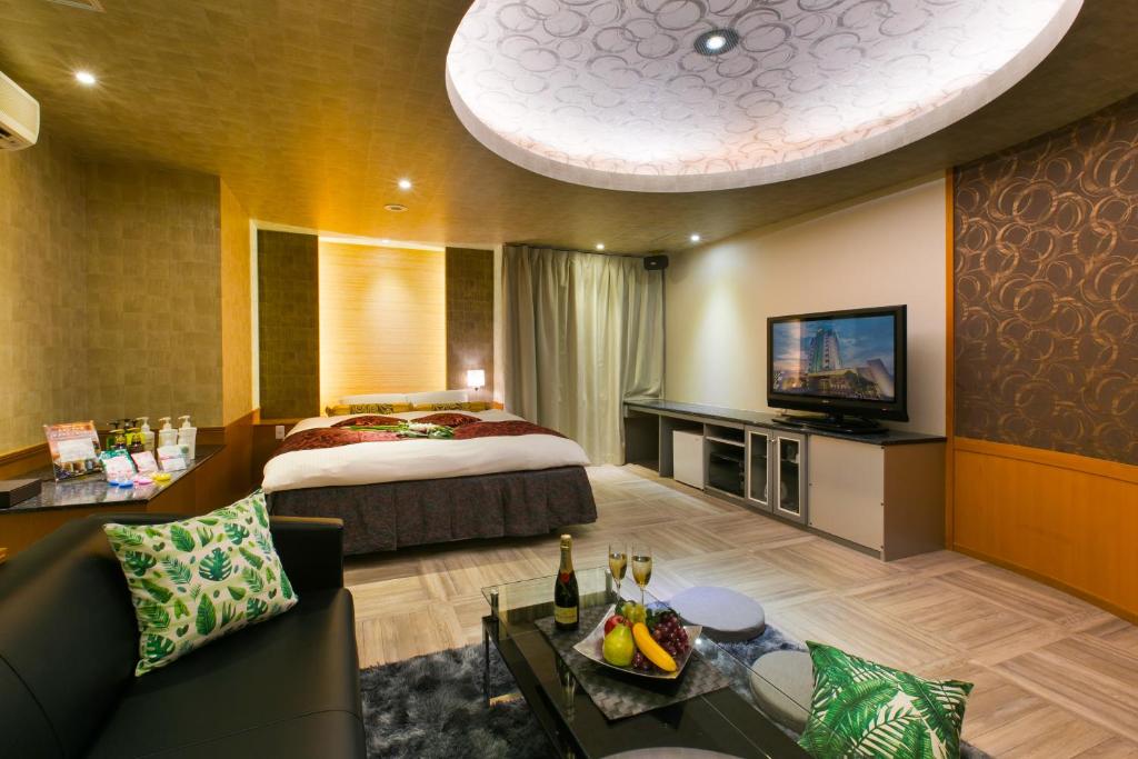 une chambre d'hôtel avec un lit et une télévision dans l'établissement ホテルジップスタイル, à Sendohira